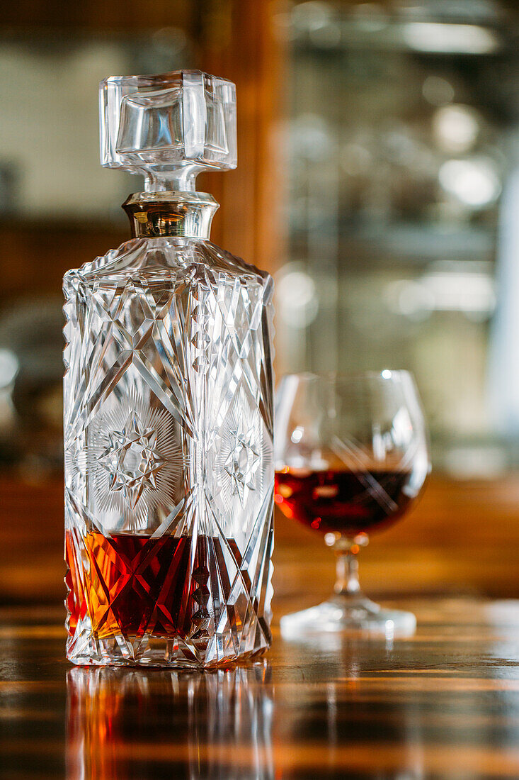 Old fashioned cognac glass on wooden table with natural light