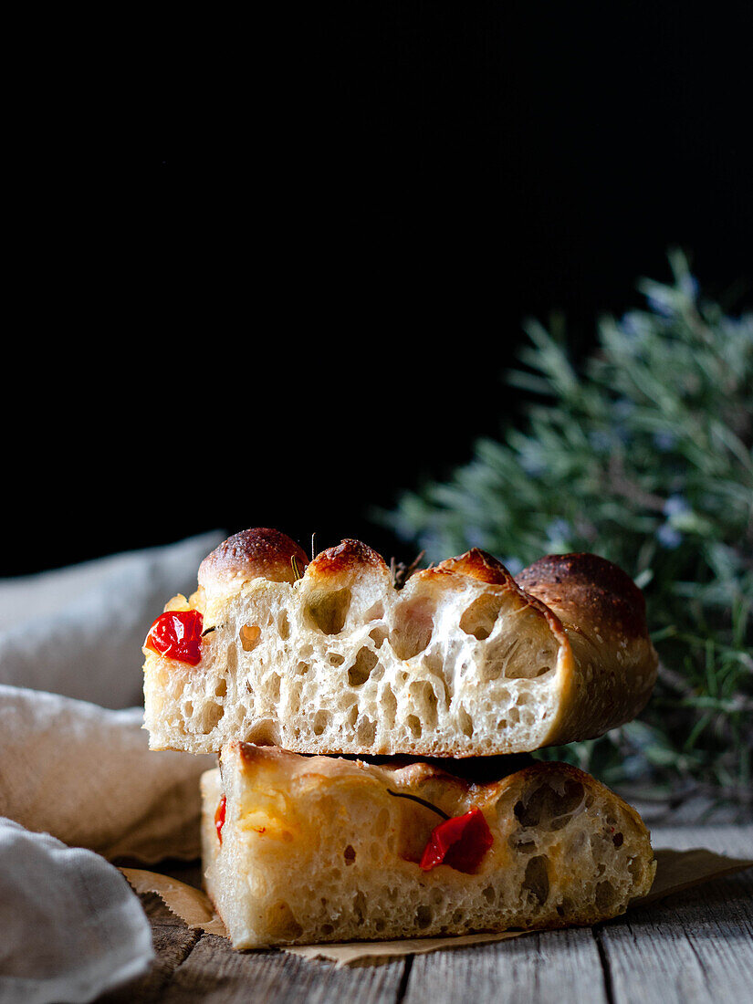Close up of one piece of fresh tomato focaccia with rosemary