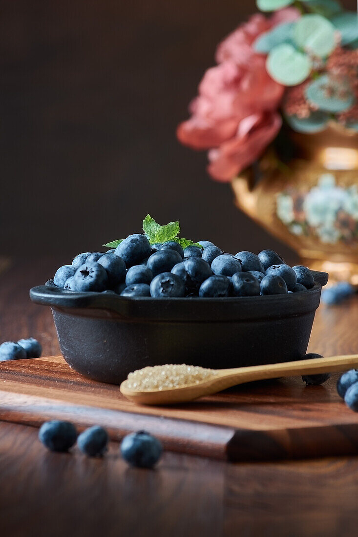 Detail of blueberries in a bowl on the wooden table