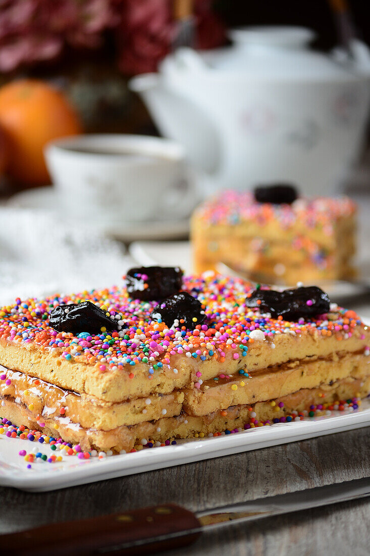 Delicious traditional Turron de Dona Pepa dessert with colorful dragee served on plate on table