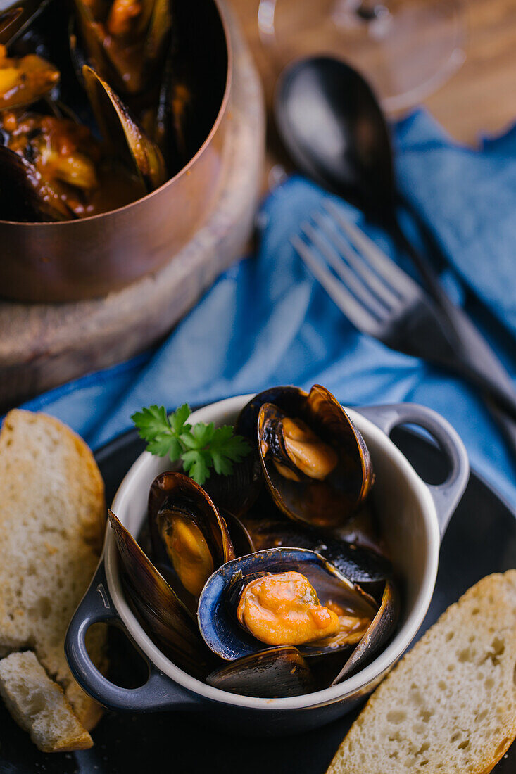 Delectable mussels with herbs in metal saucepan