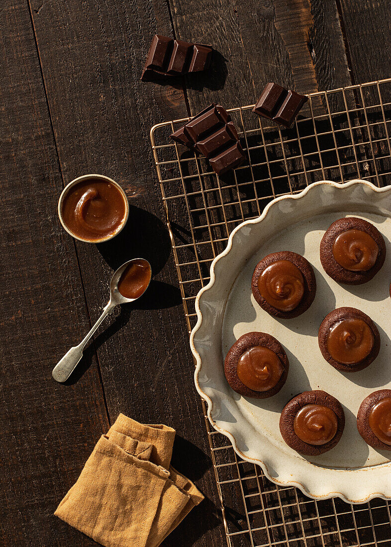 From above salted caramel chocolate cookies on ceramic plate on wooden table background