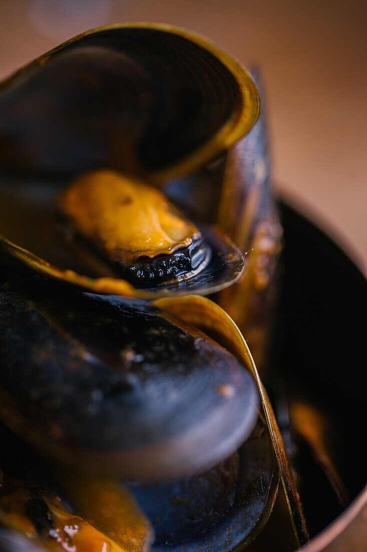 Delectable mussels with herbs in metal saucepan