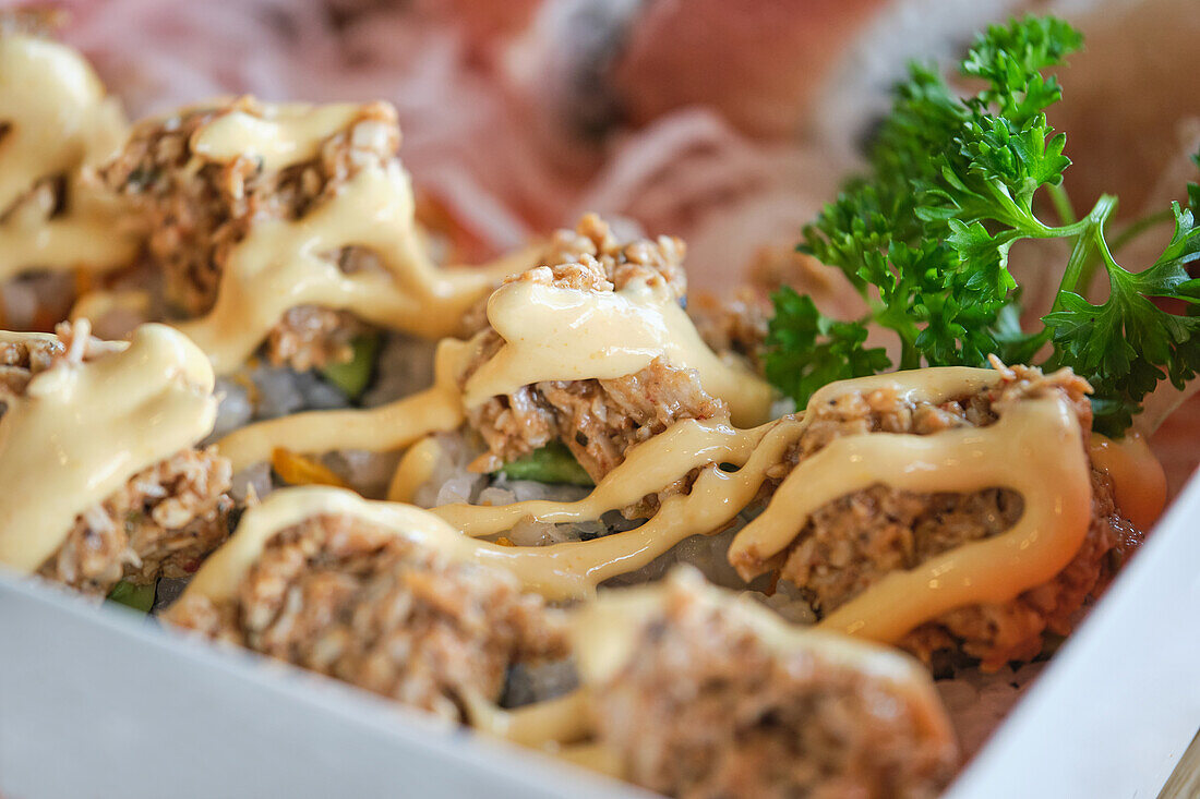 Stock photo of delicious box of sushi with special sauces.