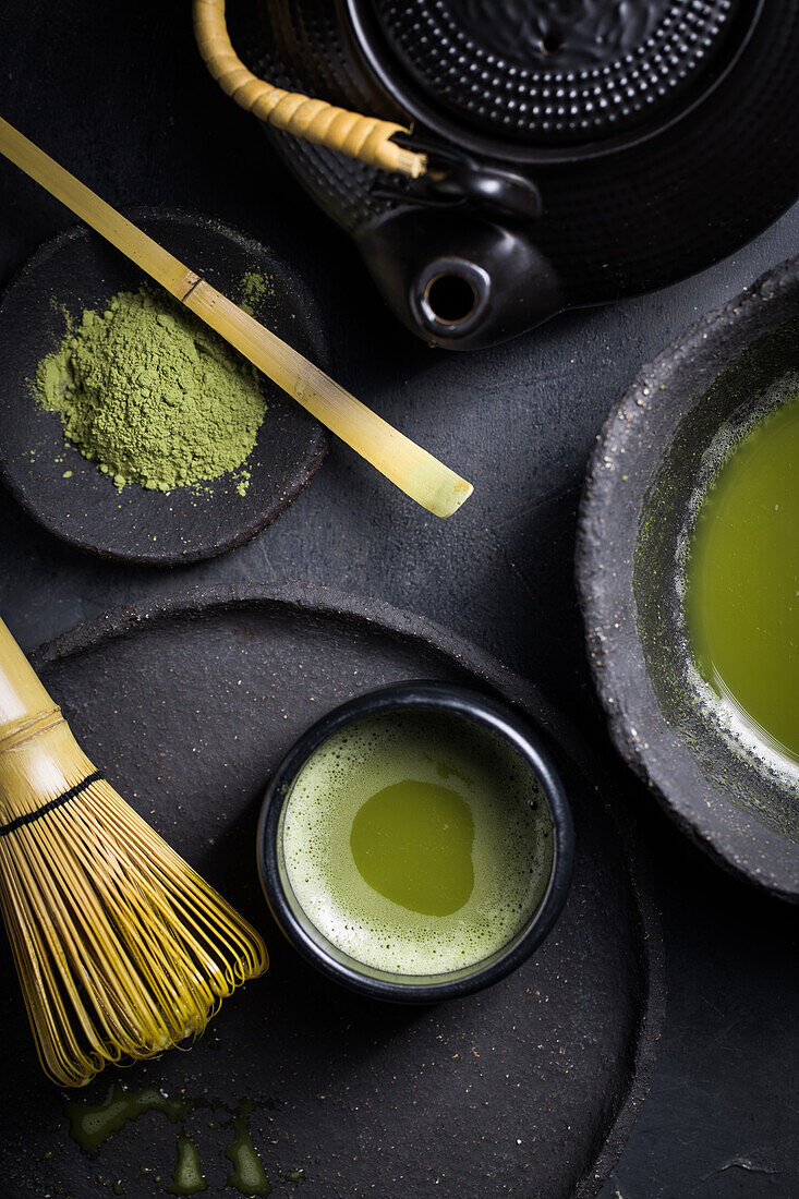 From above of traditional Japanese matcha with tea whisk in stone bowl for traditional oriental ceremony