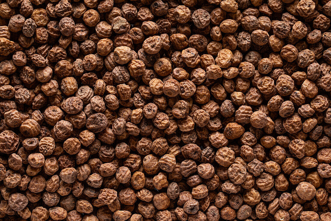 Background top view of heap made from tiger nut arranged on surface