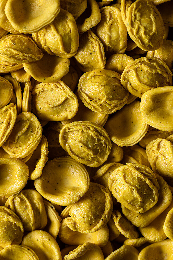 Full frame top view of fresh savory Turmeric orecchitte paste scattered on surface