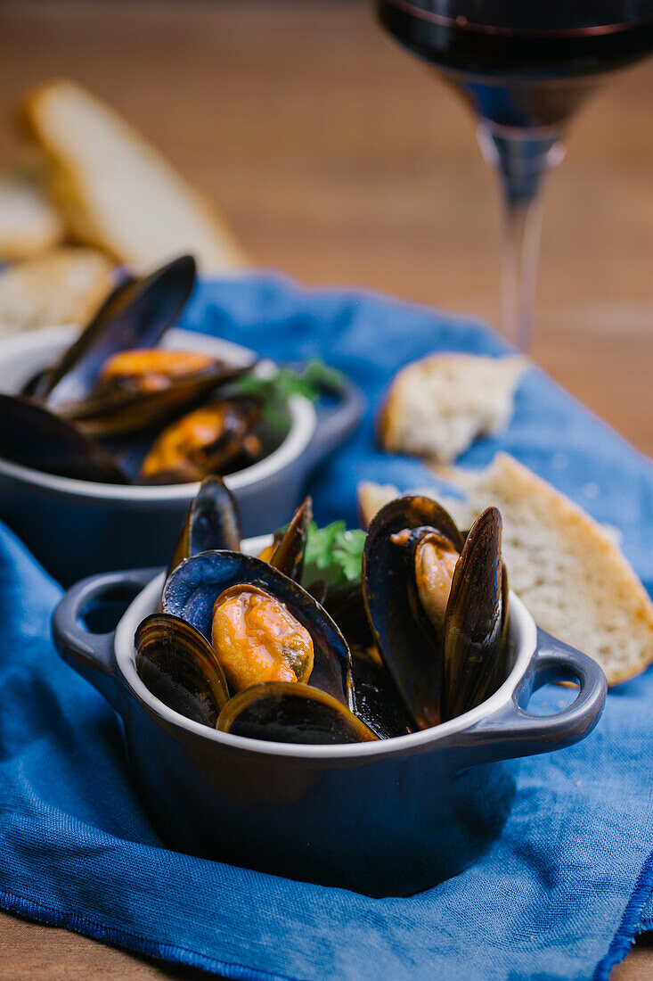 Delectable mussels with herbs in metal saucepan