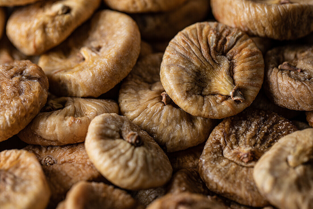 Full frame high angle of shrunken dehydrated Turkish figs stacked in pile on counter