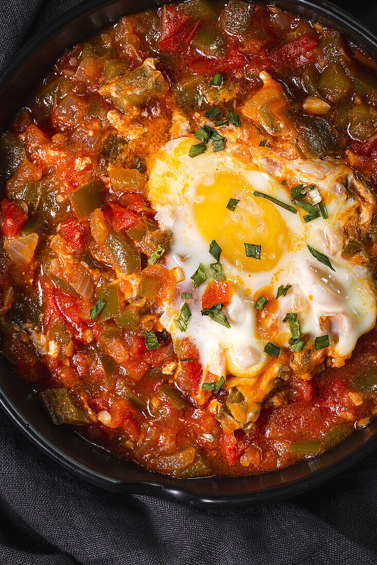 High angle of appetizing traditional Spanish dish made of egg and assorted vegetables and served in bowl on table