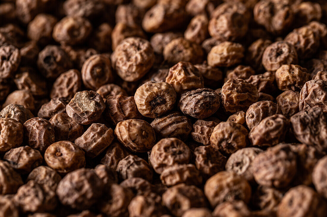 Background top view of heap made from tiger nut arranged on surface