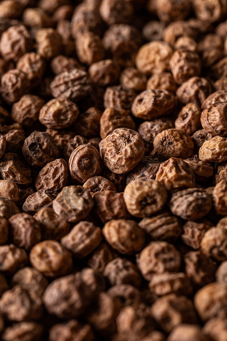 Background top view of heap made from tiger nut arranged on surface