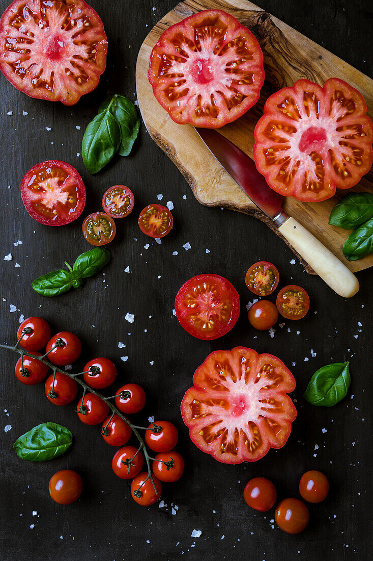 From above half cut tomatoes on table