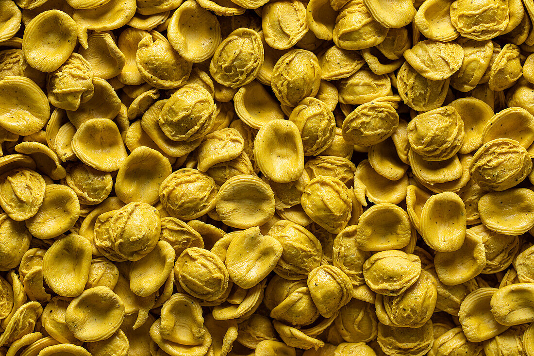 Full frame top view of fresh savory Turmeric orecchitte paste scattered on surface