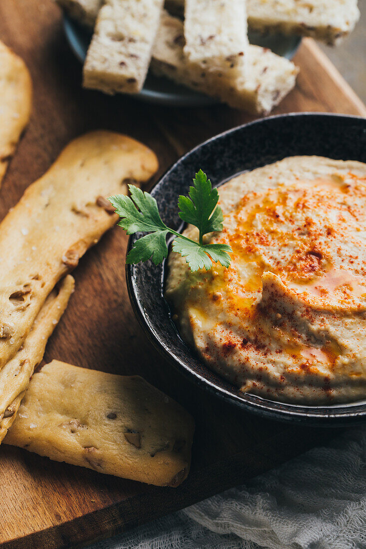 Delicious hummus with paprika, olive oil and some bread to dip