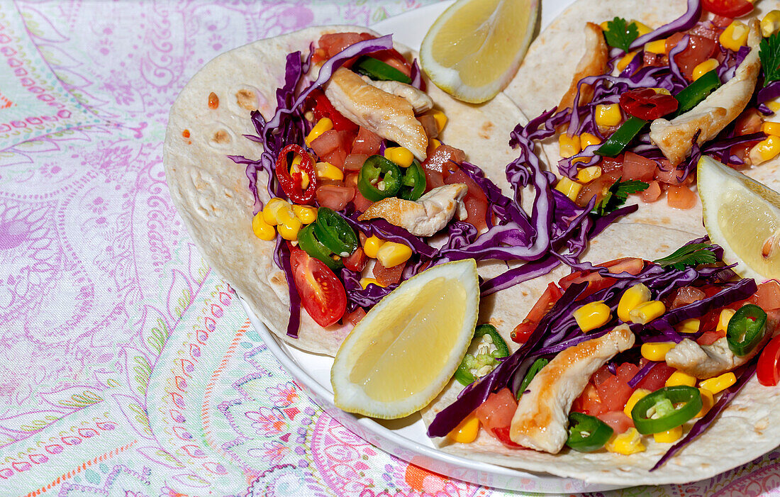 Homemade Mexican Tacos with fresh vegetables and chicken with strong light on color background. Healthy food. Typical Mexican
