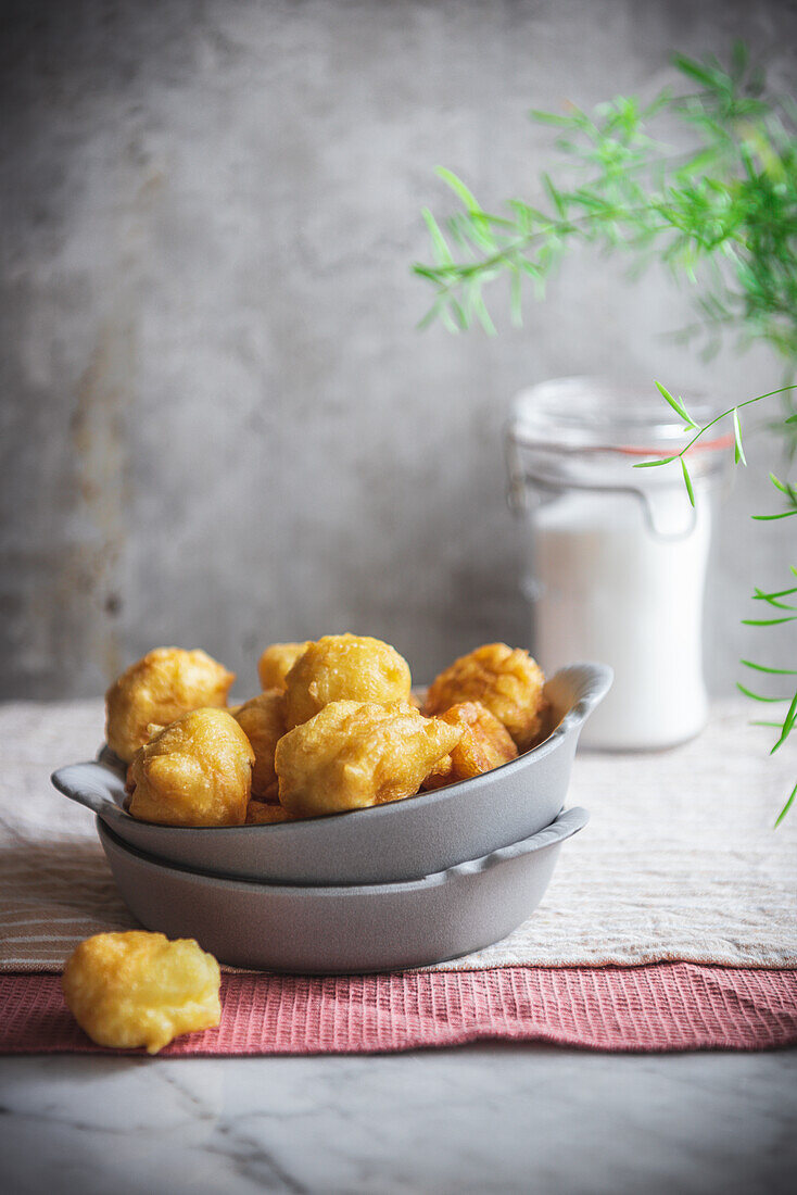 Bowl with crunchy nun's puffs bites placed on table in kitchen at home