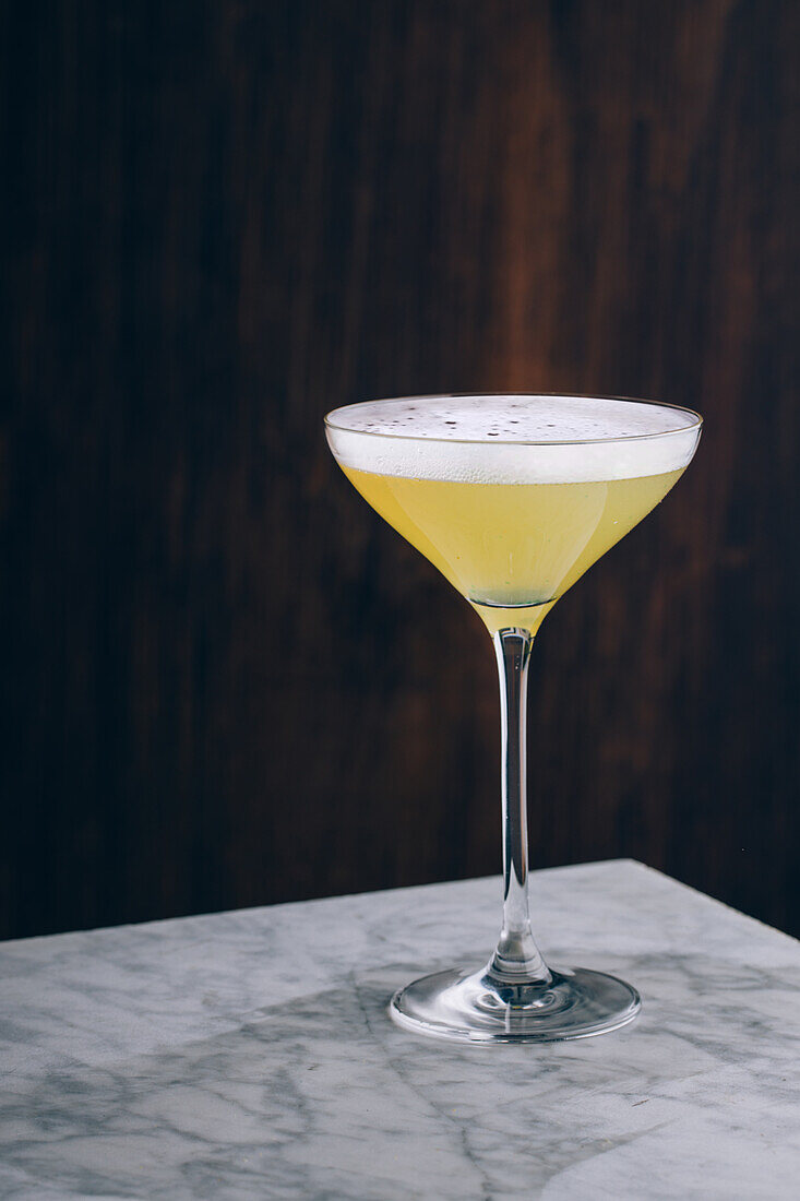 Glass of refreshing alcohol Daiquiri cocktail with rum and lime juice served on table