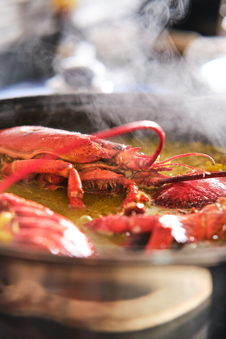 Typical Spanish fideuá with red prawns in cooking pot