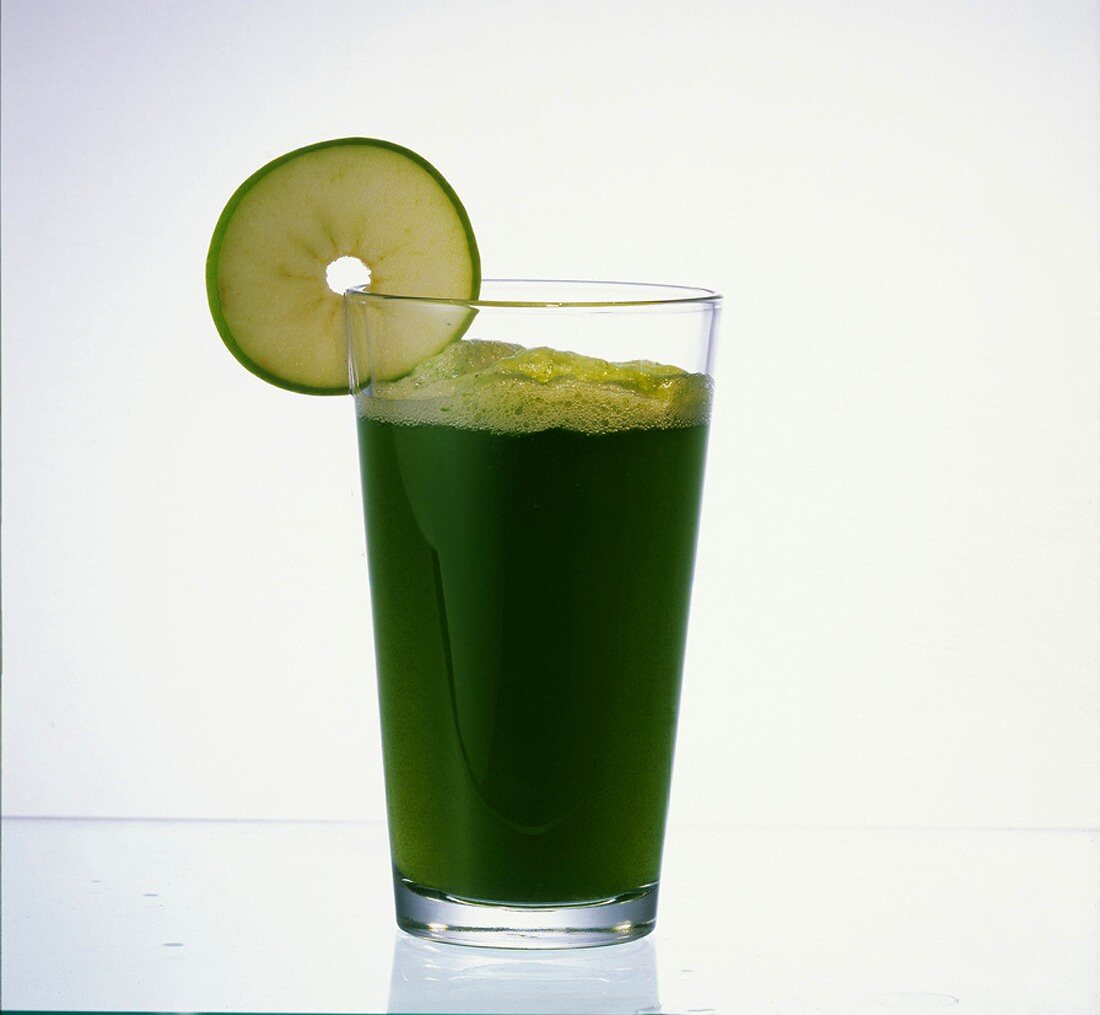 Grass juice in glass, garnished with apple slice