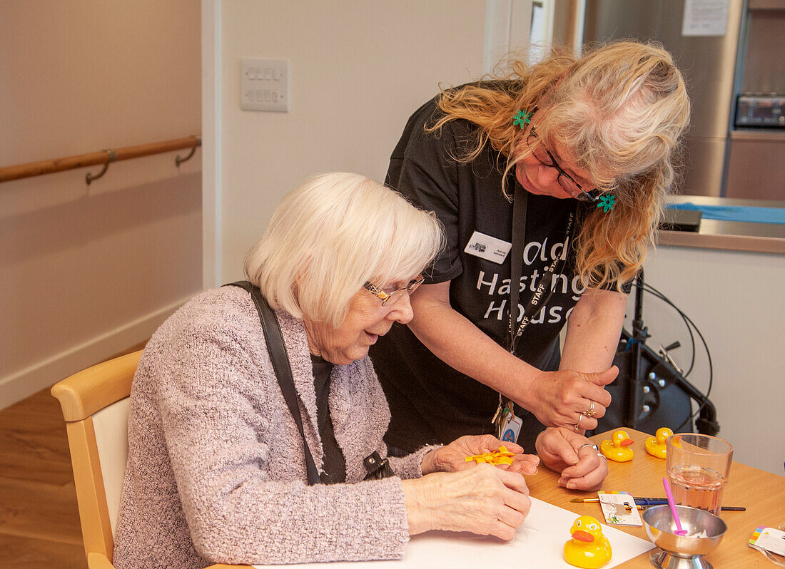 Care home resident taking part in activity