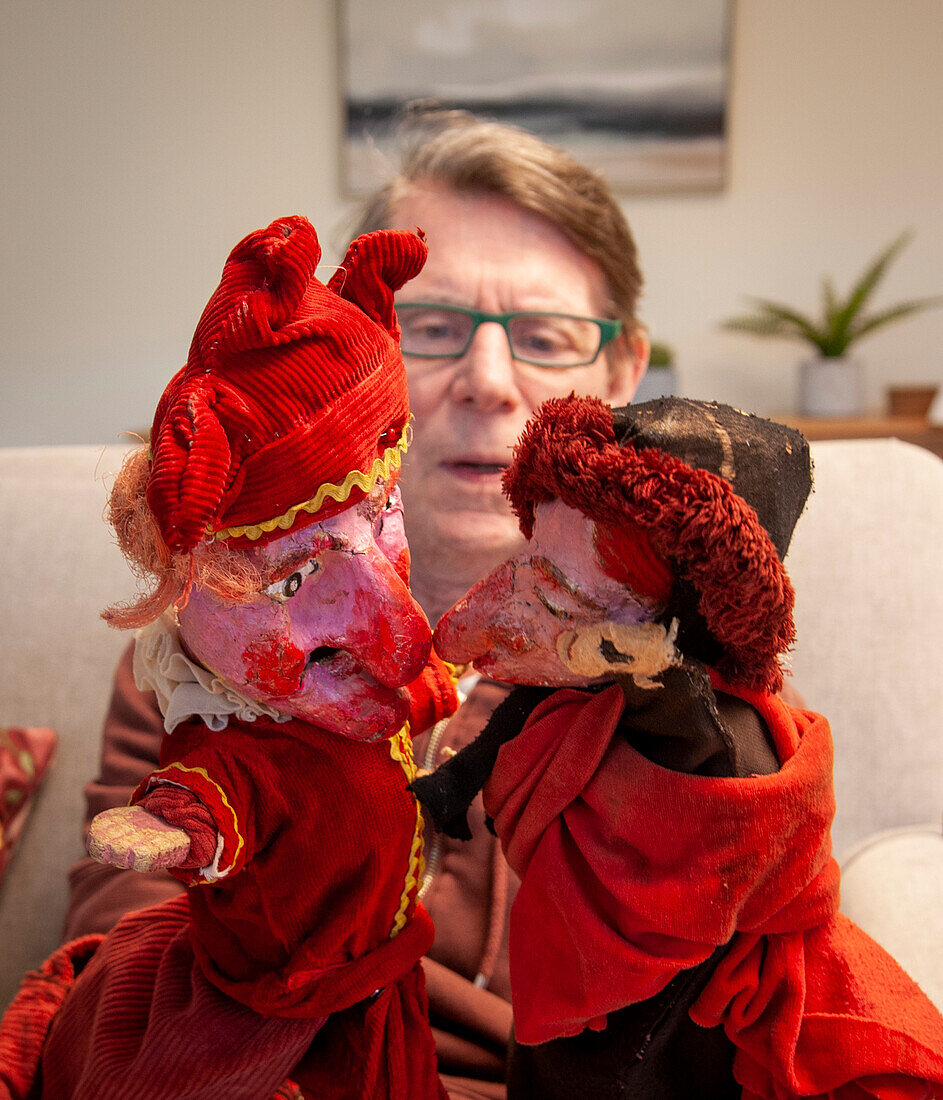 Care home resident with puppets