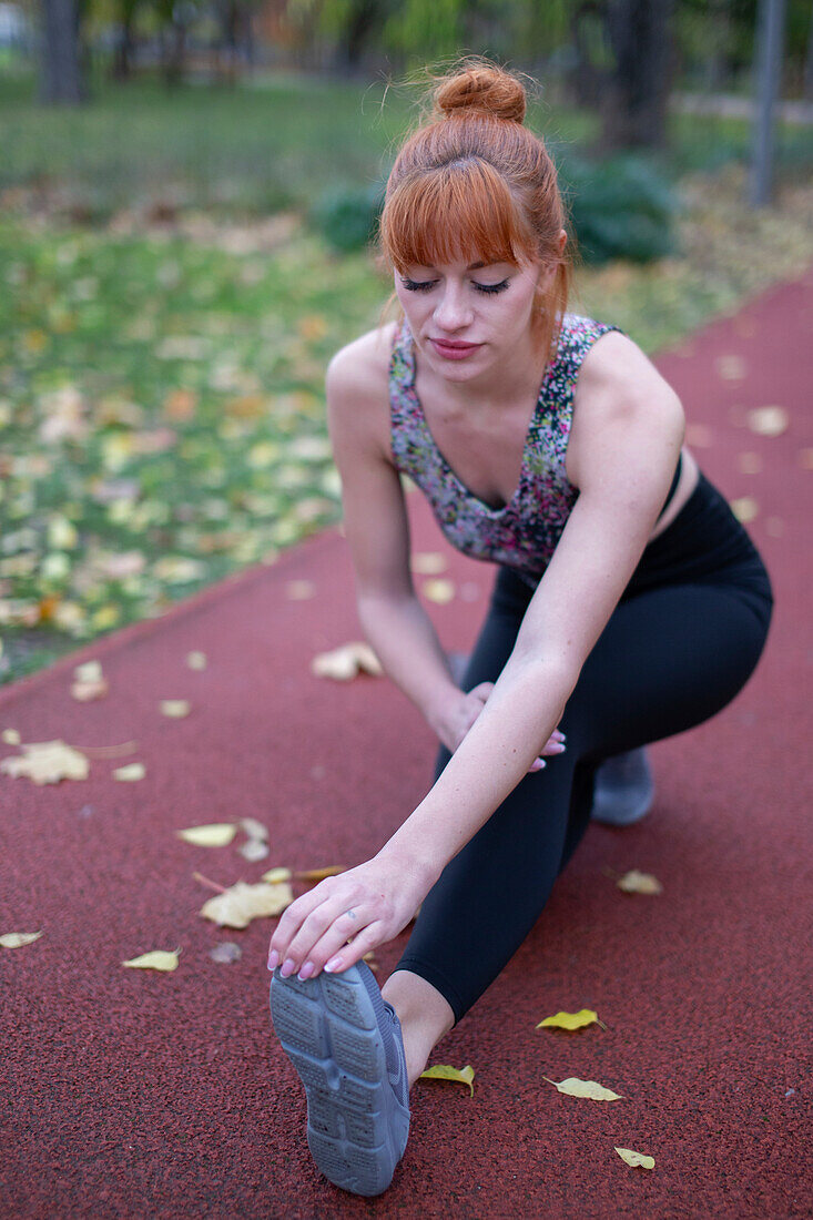 Young woman warming up before running