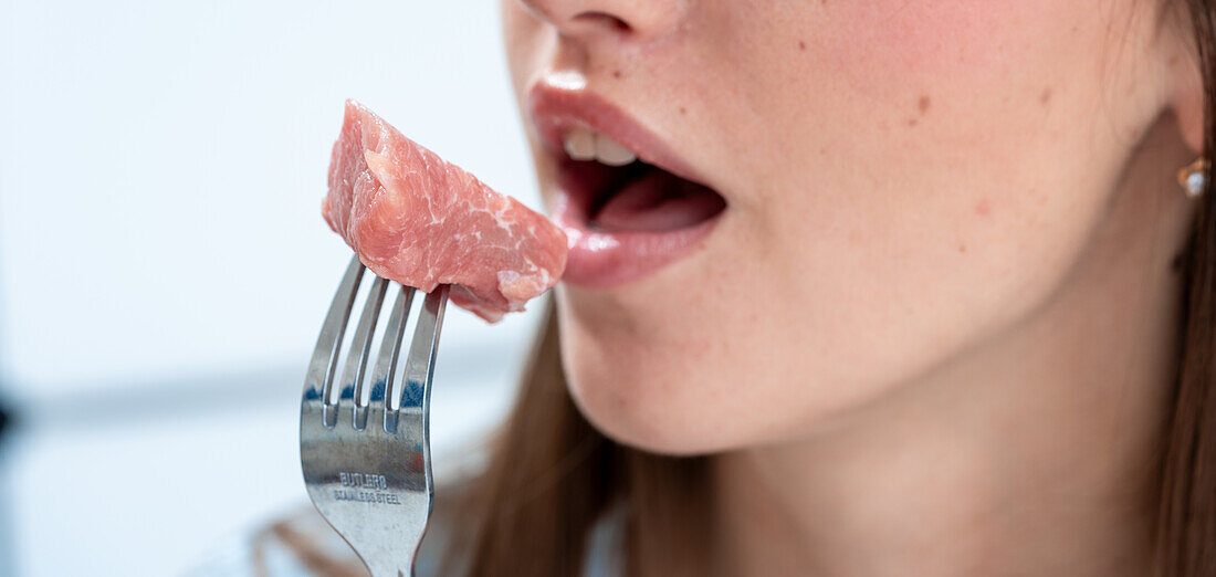 Woman eating red meat