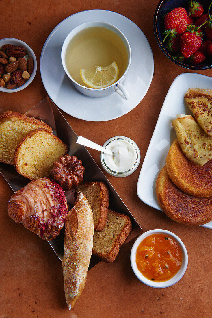 Sweet breakfast with lemon tea and pastries