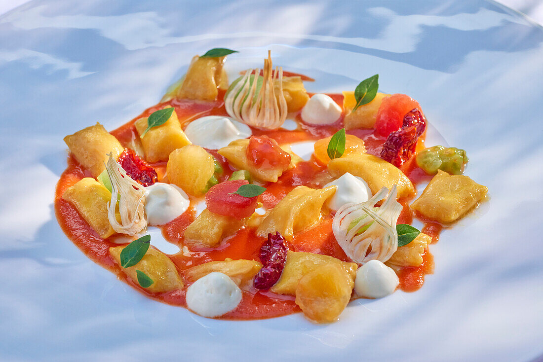 Mini ravioli with vegetables in tomato sauce