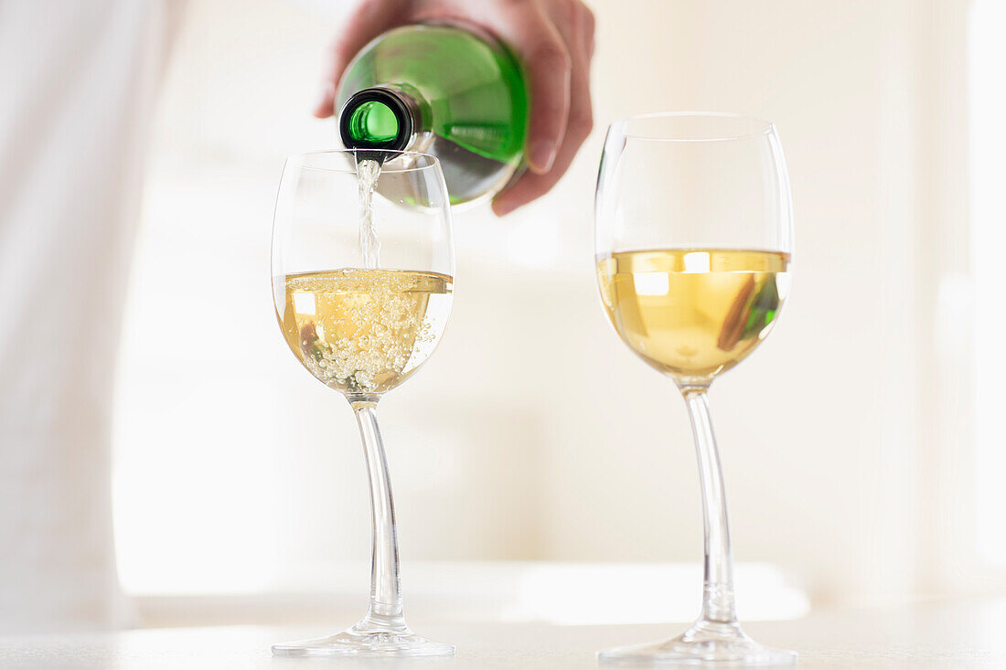 White wine being poured into a glass