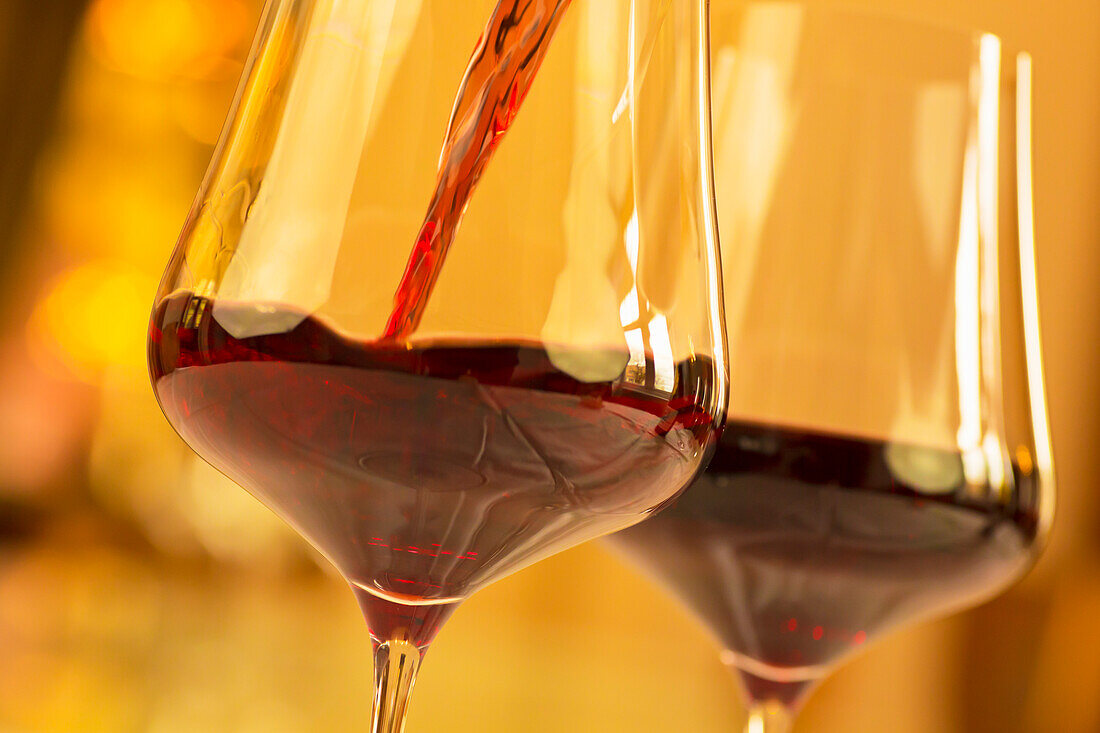 Red wine is poured into a glass