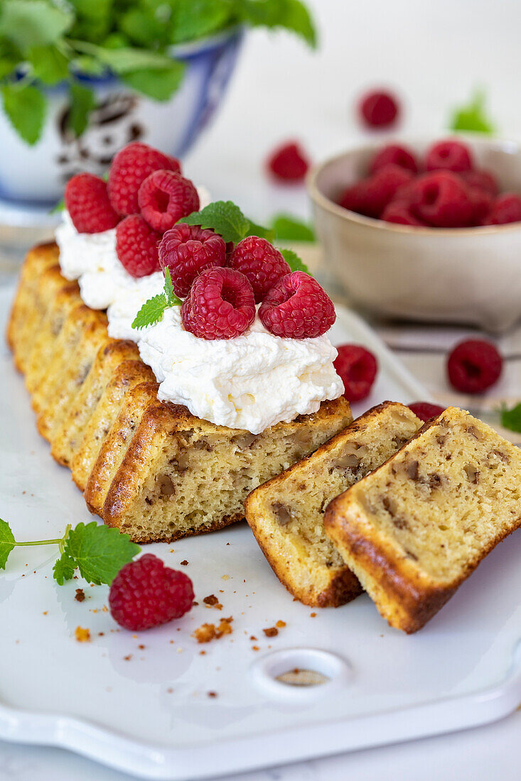 Date cake with cream and fresh raspberries