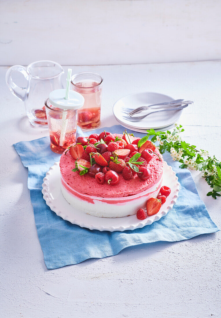 Wave cake with red berries and cherries