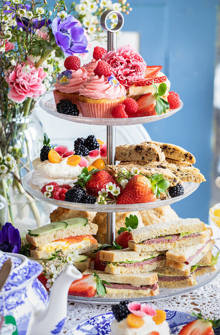 High tea with sweet pastries and sandwiches