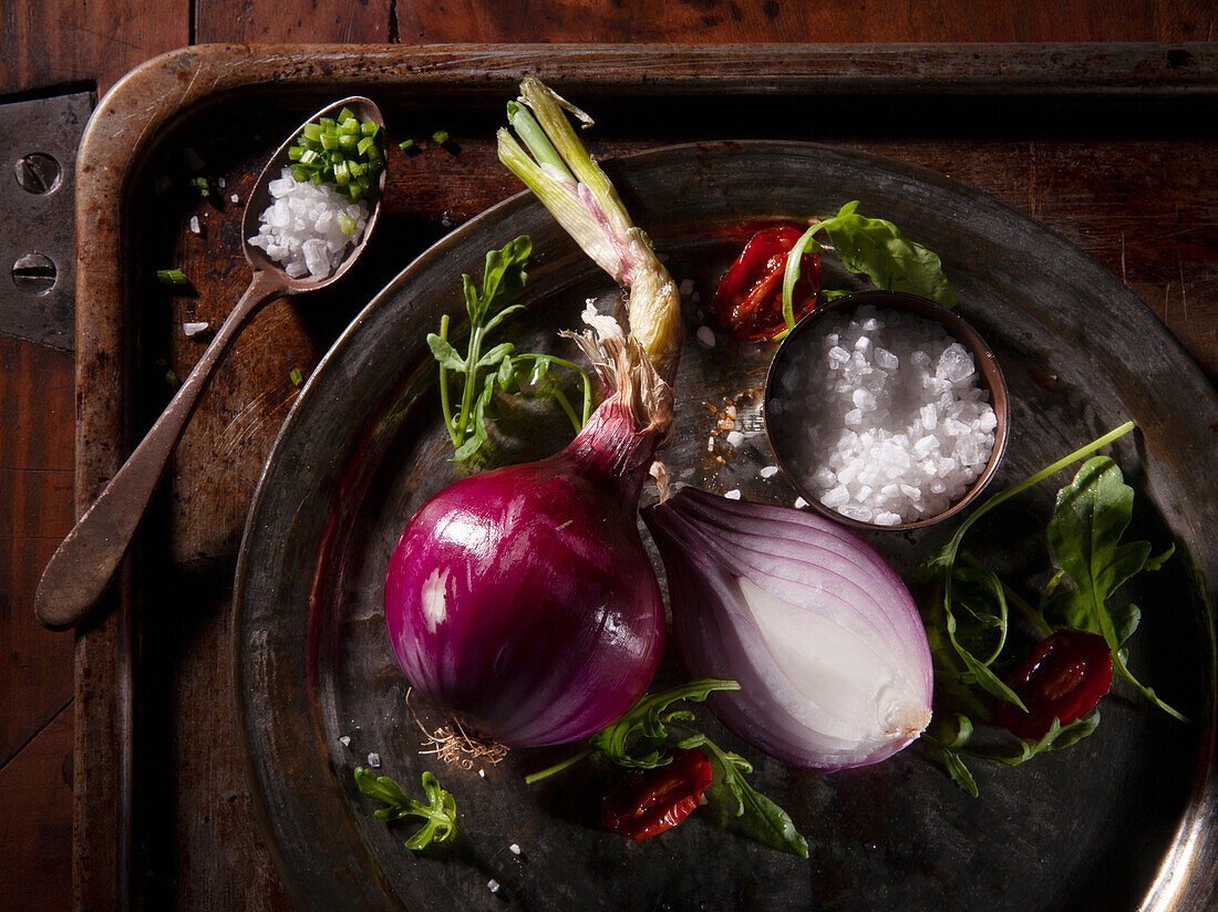 Sliced red onion with rocket, roasted cherry tomatoes and coarse salt