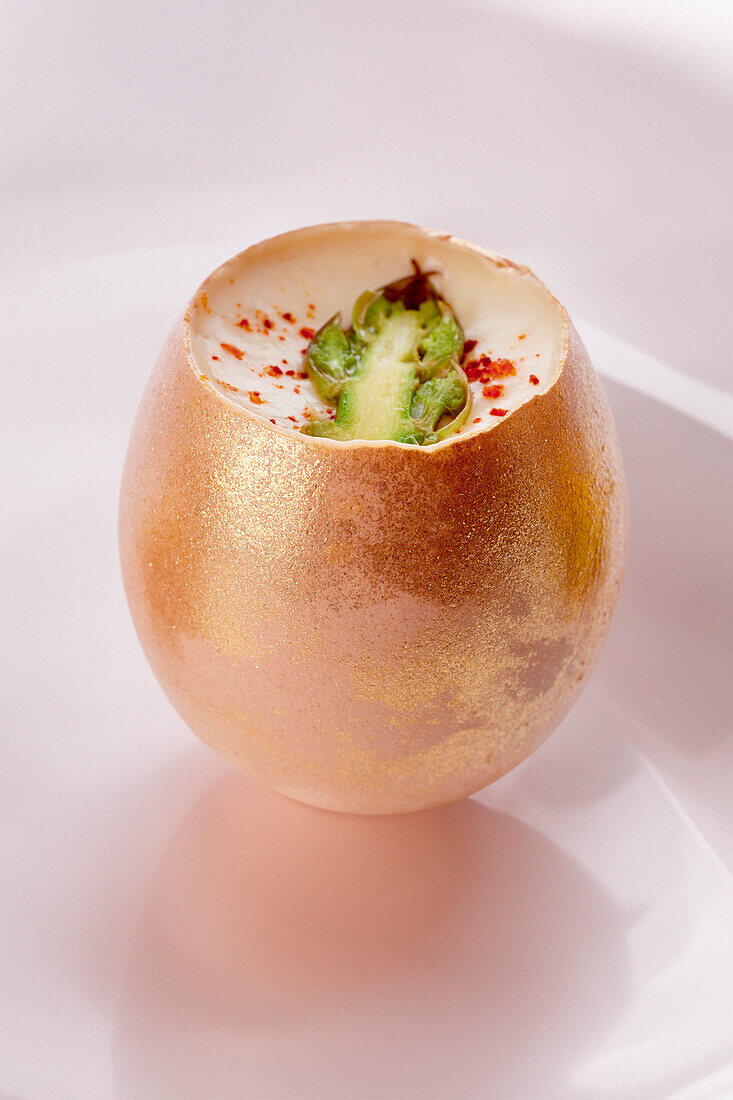 Stuffed egg with asparagus and parmesan cream and paprika