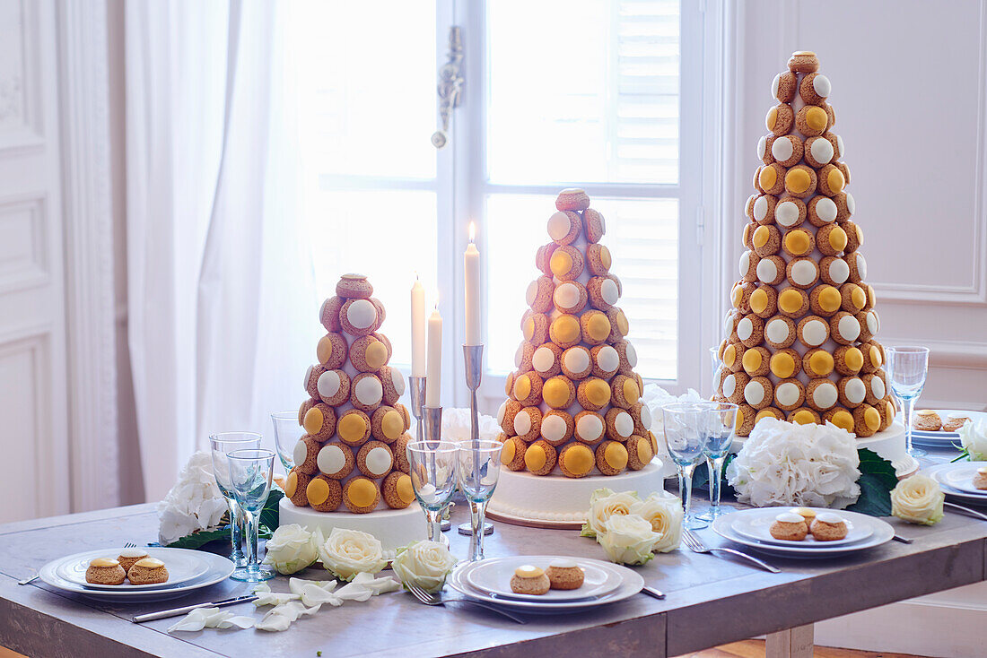Festive table decoration with pyramids made from cream puffs