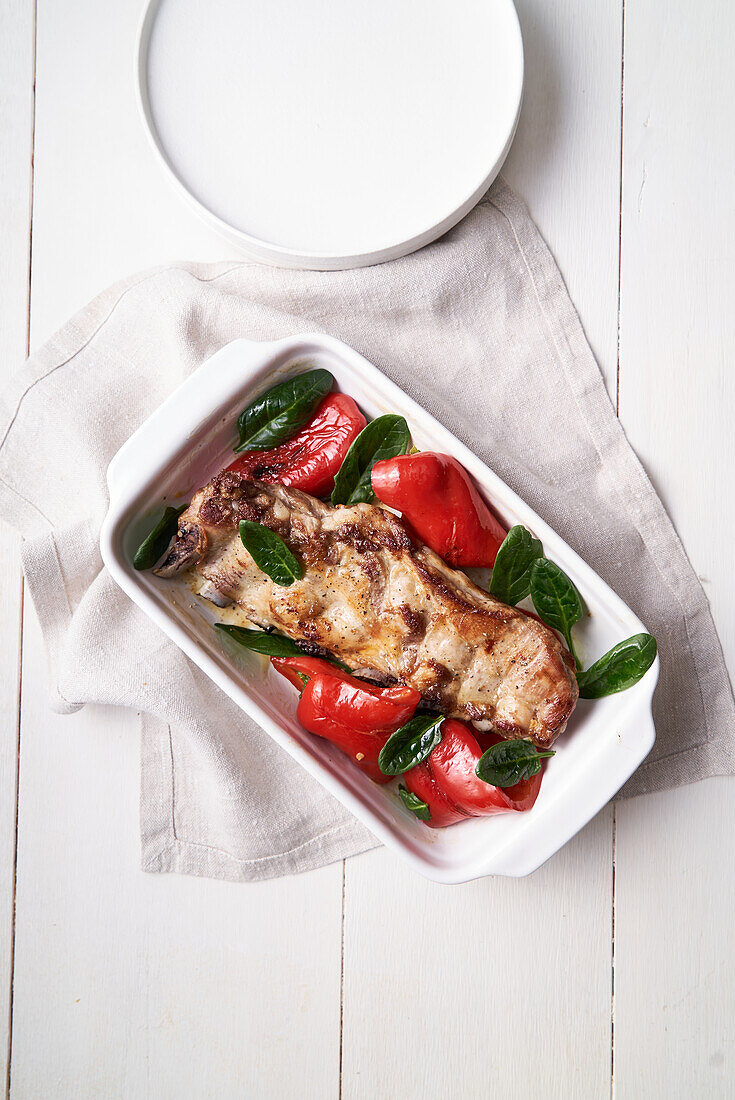 Fried pork ribs with peppers and basil