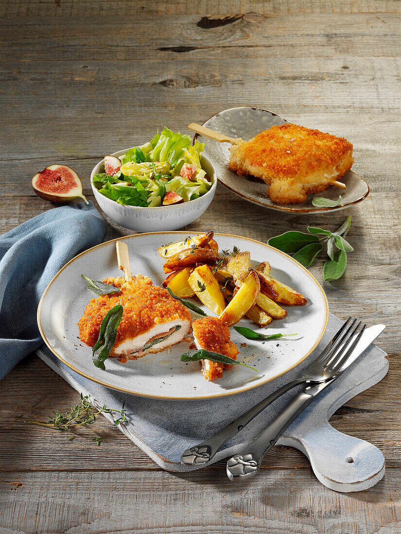 Breaded chicken saltimbocca with jacket potatoes and salad