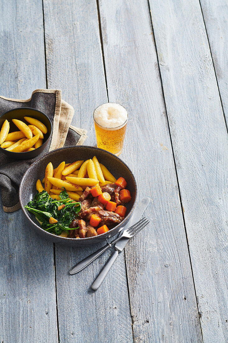 Beer-braised turkey bites with carrots, spinach and potato noodles