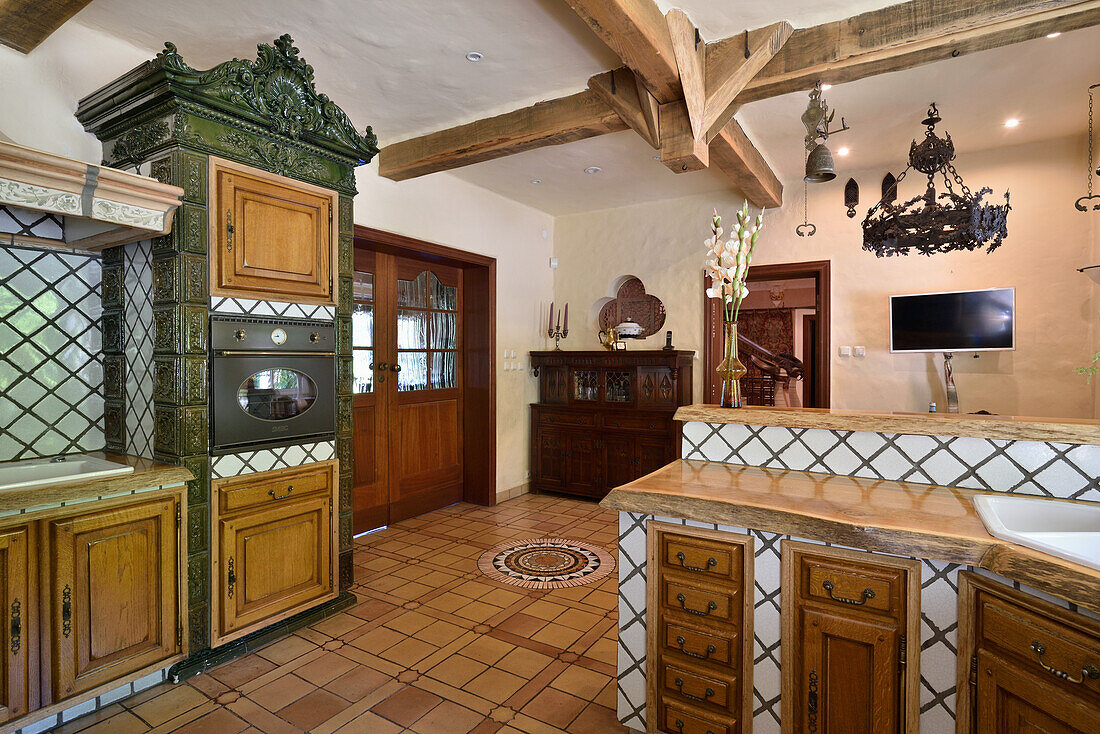 Rustic kitchen with wooden cupboards and ceramic tiles