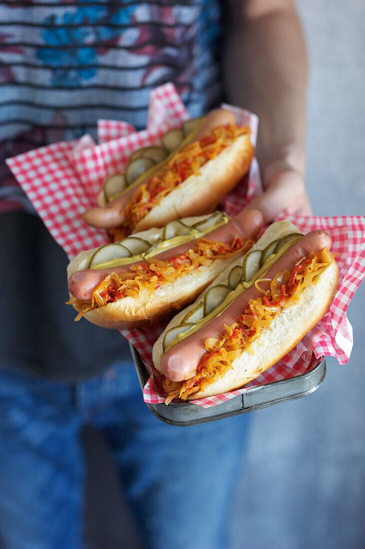 Hot dogs with fried onions and cucumber