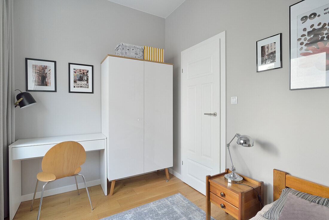 Bedroom with work area in a two-room flat in Warsaw