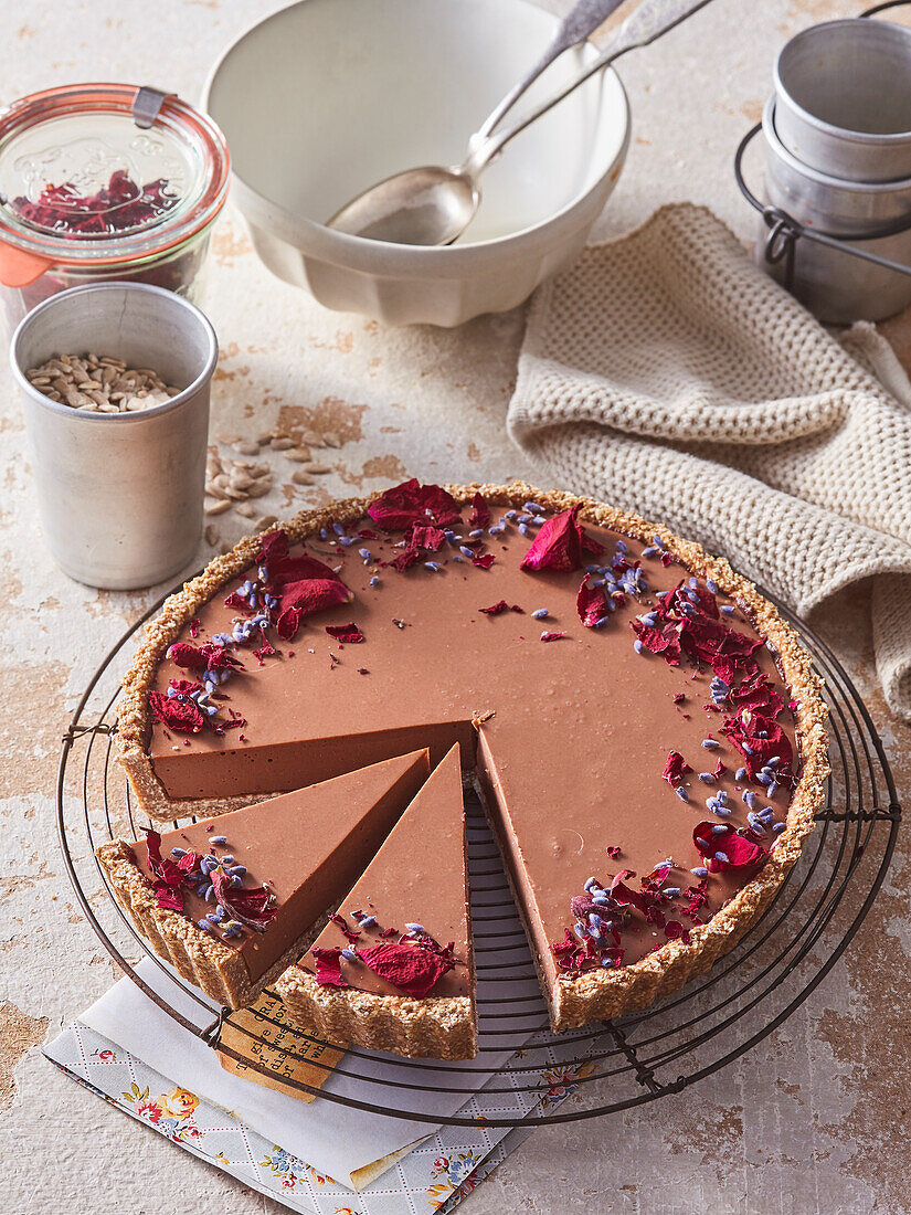 Chocolate cake with edible flowers and sunflower seeds