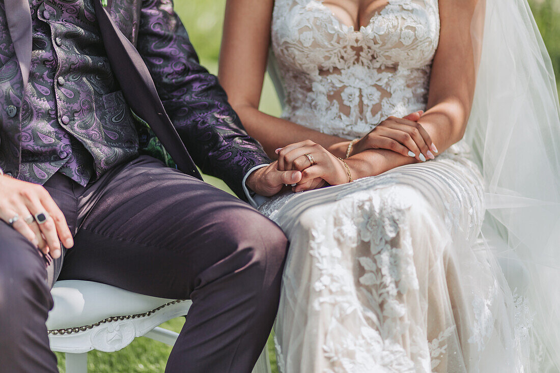 Bride and groom in festive attire holding hands during wedding ceremony