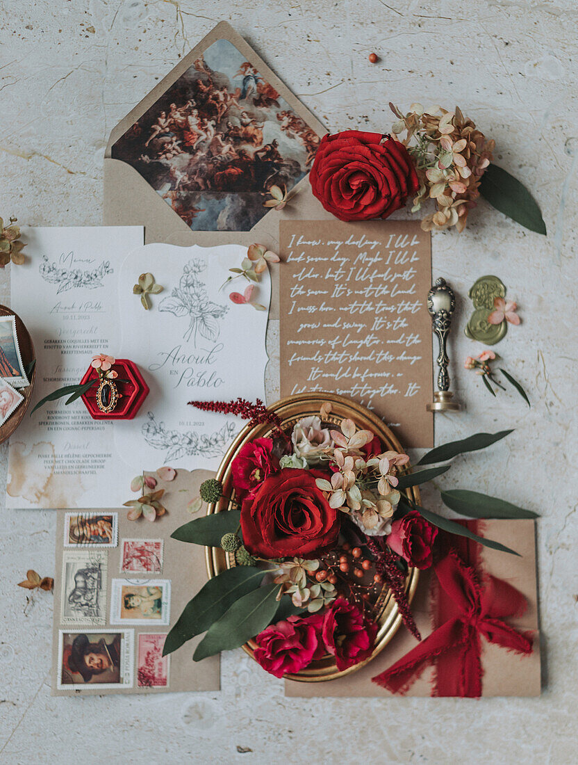 Wedding invitations with red roses and vintage accessories