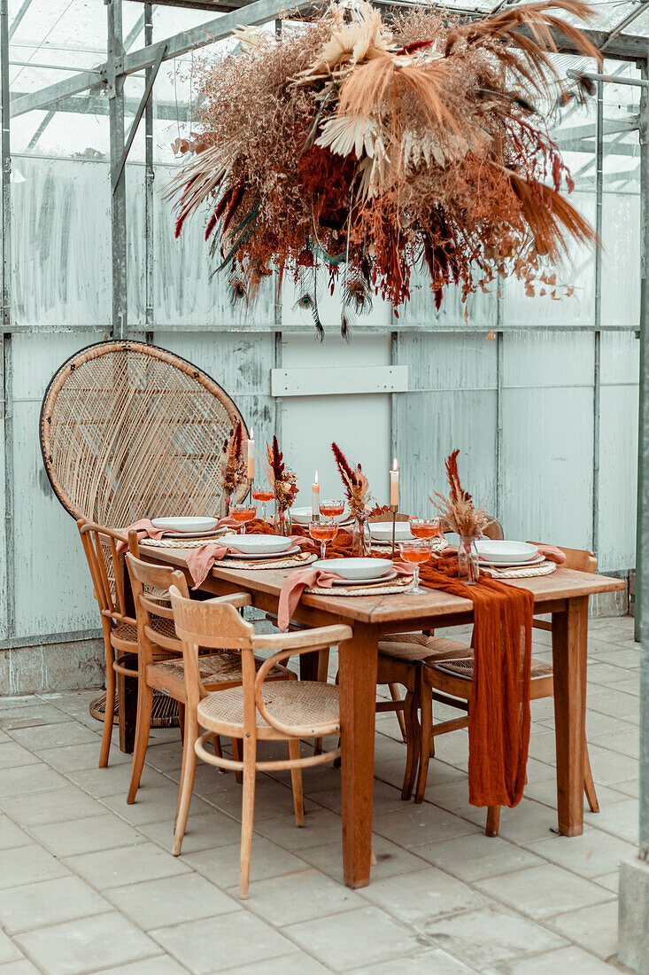 Dining table set with dried flowers in a greenhouse