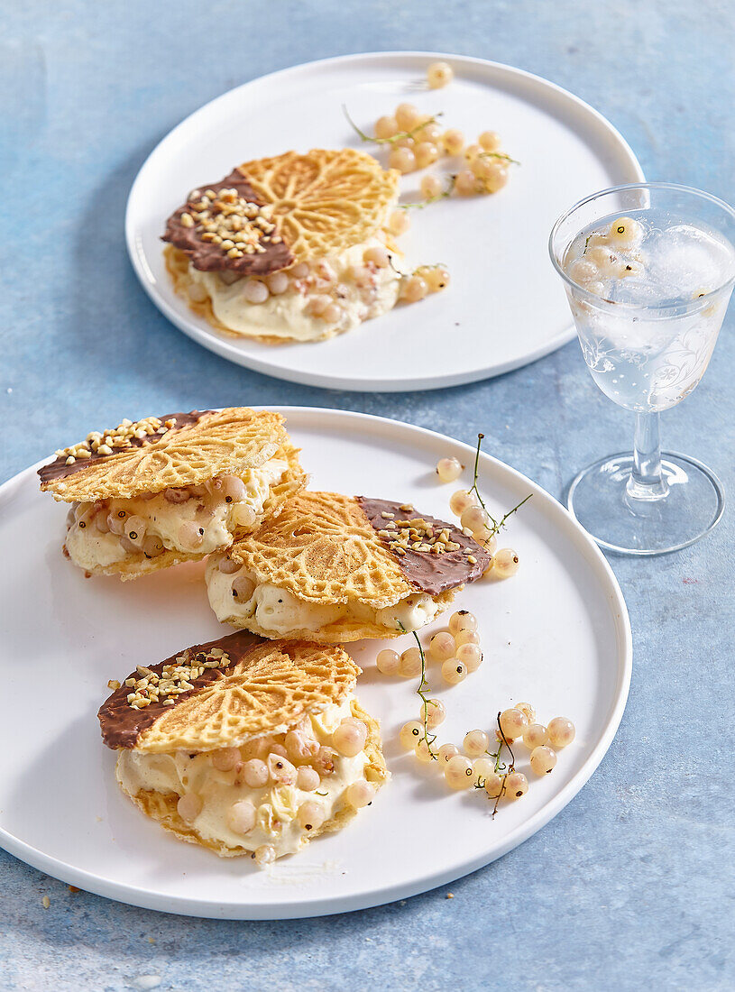 Waffle ice cream sandwich with whitecurrants, chocolate icing and hazelnuts