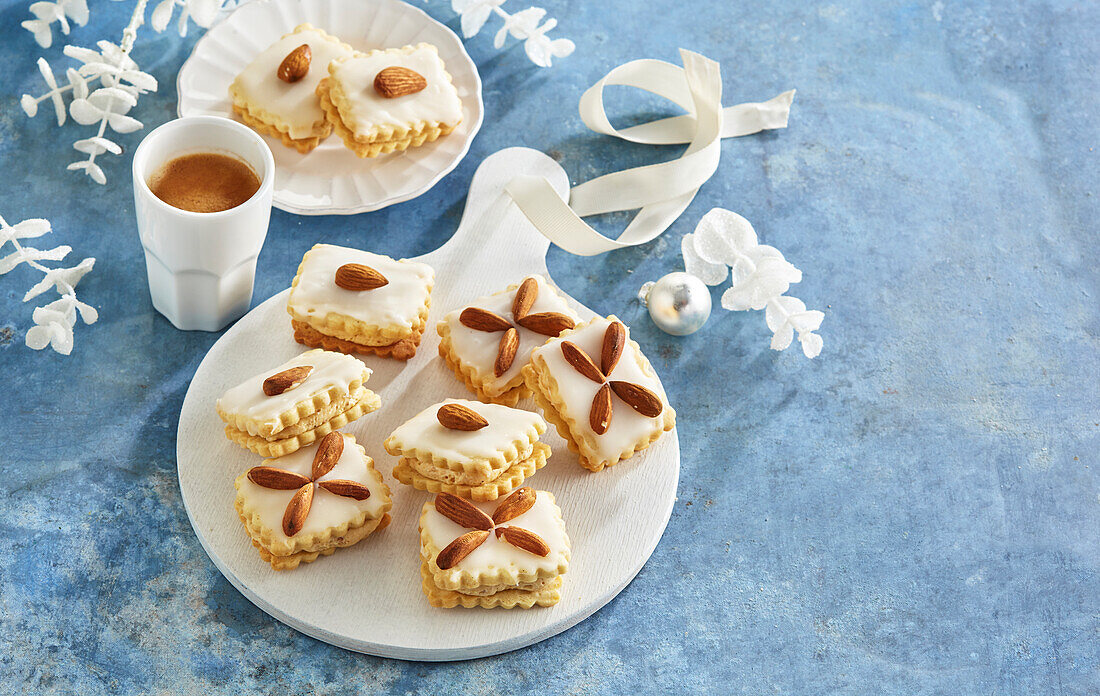 Christmas biscuits with walnut filling and almond decoration